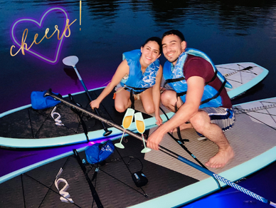 Couple on glow paddle boards